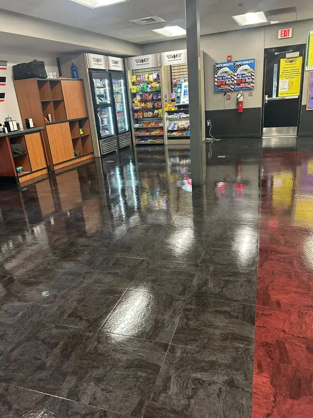 Polished dark tile floor in a retail interior kept on a nightly cleaning round