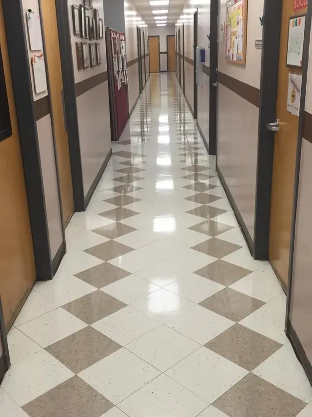 Polished corridor floor in a school building with a diamond pattern tile layout
